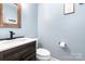 Stylish powder room with dark wood vanity and modern faucet at 4002 Solomons Ct, Monroe, NC 28110