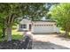 Inviting home exterior with landscaped front yard and a two-car garage, showcasing curb appeal at 4002 Solomons Ct, Monroe, NC 28110