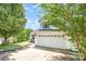 Beautifully landscaped home exterior featuring a two-car garage and lush greenery at 4002 Solomons Ct, Monroe, NC 28110
