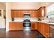Well-lit kitchen features stainless steel appliances, wood cabinets, and white countertops at 4002 Solomons Ct, Monroe, NC 28110