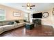 Cozy living room featuring hardwood floors, large couch, and a fireplace at 4002 Solomons Ct, Monroe, NC 28110