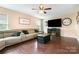 Comfortable living room with plush sofa, hardwood floors, and cozy fireplace at 4002 Solomons Ct, Monroe, NC 28110