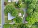 An aerial view of a property with mature trees, outbuildings, and a well-maintained yard at 402 School St, Rockwell, NC 28138