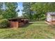 This backyard features a brick outdoor kitchen under a covered patio, perfect for outdoor gatherings and barbecues at 402 School St, Rockwell, NC 28138