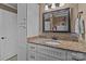 Bathroom with granite countertops, white cabinets and a modern mirror at 402 School St, Rockwell, NC 28138