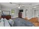 Bedroom with hardwood floors, dresser, ceiling fan, and a view into the bathroom at 402 School St, Rockwell, NC 28138
