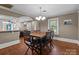 Traditional dining room with wood floors, decorative chandelier, and adjacent living space, perfect for entertaining at 402 School St, Rockwell, NC 28138
