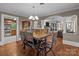 Dining room with views of the kitchen and living room, and a modern chandelier above a wooden table at 402 School St, Rockwell, NC 28138