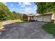 Charming brick home with an attached two-car garage and a long driveway in a serene, leafy setting at 402 School St, Rockwell, NC 28138