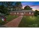Charming brick home with well-maintained lawn, brick pathway, and a mailbox decorated with a North Carolina flag at 402 School St, Rockwell, NC 28138