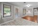 Sunny living room with windows, hardwood flooring, and a door to the outside at 402 School St, Rockwell, NC 28138