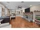Open-concept living room with hardwood floors, a stone fireplace, and ample seating, perfect for entertaining at 402 School St, Rockwell, NC 28138