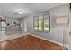 Bright living room with ample windows, a door to the backyard, and seamless access to the kitchen at 402 School St, Rockwell, NC 28138