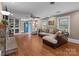 Bright living room featuring hardwood floors, built-in shelving, a fireplace, and comfortable seating, ideal for relaxing at 402 School St, Rockwell, NC 28138