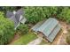 Aerial view of home, outbuilding, and deck surrounded by lush greenery at 4038 Forest Brook Dr, Edgemoor, SC 29712