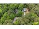 A bird's eye view of a home and barn amidst lush greenery, accessible by a winding driveway at 4038 Forest Brook Dr, Edgemoor, SC 29712