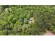 An aerial view showcases the home surrounded by a dense canopy of trees at 4038 Forest Brook Dr, Edgemoor, SC 29712