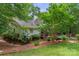 The backyard features a home with a wooden deck and a landscaped yard at 4038 Forest Brook Dr, Edgemoor, SC 29712