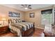 Bedroom featuring hardwood floors and a patterned bedspread. Natural light shines through the window at 4038 Forest Brook Dr, Edgemoor, SC 29712