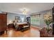 Main bedroom with hardwood floors, ceiling fan and large window at 4038 Forest Brook Dr, Edgemoor, SC 29712
