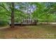Charming two-story home with a large front deck and plenty of shade trees at 4038 Forest Brook Dr, Edgemoor, SC 29712