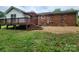 Backyard featuring a wooden deck, patio, grass and brick exterior at 409 S Martin Luther King Jr Ave, Salisbury, NC 28144