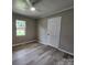 Bedroom featuring a ceiling fan, window, fresh paint, and wood-look laminate flooring at 409 S Martin Luther King Jr Ave, Salisbury, NC 28144