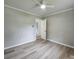 Bedroom featuring a ceiling fan, fresh paint, wood-look laminate flooring and an open doorway at 409 S Martin Luther King Jr Ave, Salisbury, NC 28144