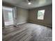 Light-filled bedroom with new floors and neutral walls and patio access at 409 S Martin Luther King Jr Ave, Salisbury, NC 28144