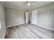 Bedroom featuring a ceiling fan, fresh paint, wood-look laminate flooring and two doorways at 409 S Martin Luther King Jr Ave, Salisbury, NC 28144