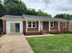 Single story brick home with white trim, covered porch and freshly landscaped front yard at 409 S Martin Luther King Jr Ave, Salisbury, NC 28144