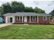 Charming single story brick home with a well-maintained lawn and inviting front porch at 409 S Martin Luther King Jr Ave, Salisbury, NC 28144
