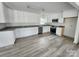 Beautiful kitchen with white cabinets, stainless steel appliances, and updated flooring at 409 S Martin Luther King Jr Ave, Salisbury, NC 28144