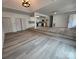 Large living area featuring wood-look floors, stairs, and access to the kitchen at 409 S Martin Luther King Jr Ave, Salisbury, NC 28144