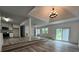 Open living area featuring wood-look floors, stairs, and a modern chandelier at 409 S Martin Luther King Jr Ave, Salisbury, NC 28144