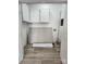 Utility room featuring storage cabinets and wood-look laminate flooring at 409 S Martin Luther King Jr Ave, Salisbury, NC 28144