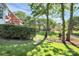 Expansive backyard featuring lush lawn, mature trees, and a charming patio area perfect for outdoor entertaining at 4509 Rosecliff Dr, Charlotte, NC 28277