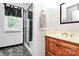 Bathroom featuring walk-in shower with glass door, wood vanity, and tile floor at 4509 Rosecliff Dr, Charlotte, NC 28277