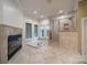 Spacious primary bath boasts a fireplace, soaking tub, and glass shower, with tile floors at 4509 Rosecliff Dr, Charlotte, NC 28277