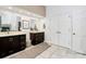 Bathroom featuring double sink vanity, large mirrors, and decorative rug at 4509 Rosecliff Dr, Charlotte, NC 28277