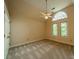 Bright bedroom with carpet, ceiling fan, and large windows offering outdoor views at 4509 Rosecliff Dr, Charlotte, NC 28277