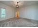 Large carpeted bedroom features an overhead light fixture, and a window for natural light at 4509 Rosecliff Dr, Charlotte, NC 28277