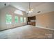 Large bonus room with a vaulted ceiling, carpeted floor, wet bar, mini fridge, and plenty of natural light from the windows at 4509 Rosecliff Dr, Charlotte, NC 28277