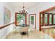 Breakfast nook featuring modern chandelier and wood trim in a room filled with natural light and neutral colors at 4509 Rosecliff Dr, Charlotte, NC 28277