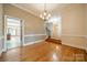 Elegant dining room with hardwood floors, crown molding, and decorative chandelier at 4509 Rosecliff Dr, Charlotte, NC 28277