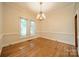 Bright dining room features hardwood floors, crown molding, and a chandelier fixture at 4509 Rosecliff Dr, Charlotte, NC 28277