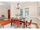 Formal dining room featuring a wooden table with seating for six, a chandelier, and natural light from two large windows at 4509 Rosecliff Dr, Charlotte, NC 28277