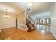 Spacious foyer with hardwood floors, staircase with iron spindles, and chandelier lighting at 4509 Rosecliff Dr, Charlotte, NC 28277