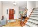 Inviting foyer featuring hardwood floors, a wooden front door with decorative glass, and a staircase leading to the upper level at 4509 Rosecliff Dr, Charlotte, NC 28277