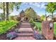 Charming brick home with a welcoming entrance, landscaped garden, and a brick staircase leading to the front door at 4509 Rosecliff Dr, Charlotte, NC 28277